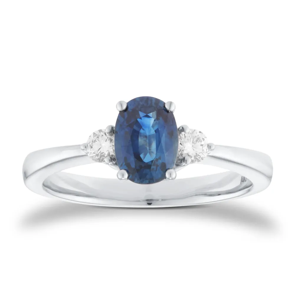 Platinum Oval Cut Sapphire and 0.15cttw Diamond Three Stone Engagement Ring